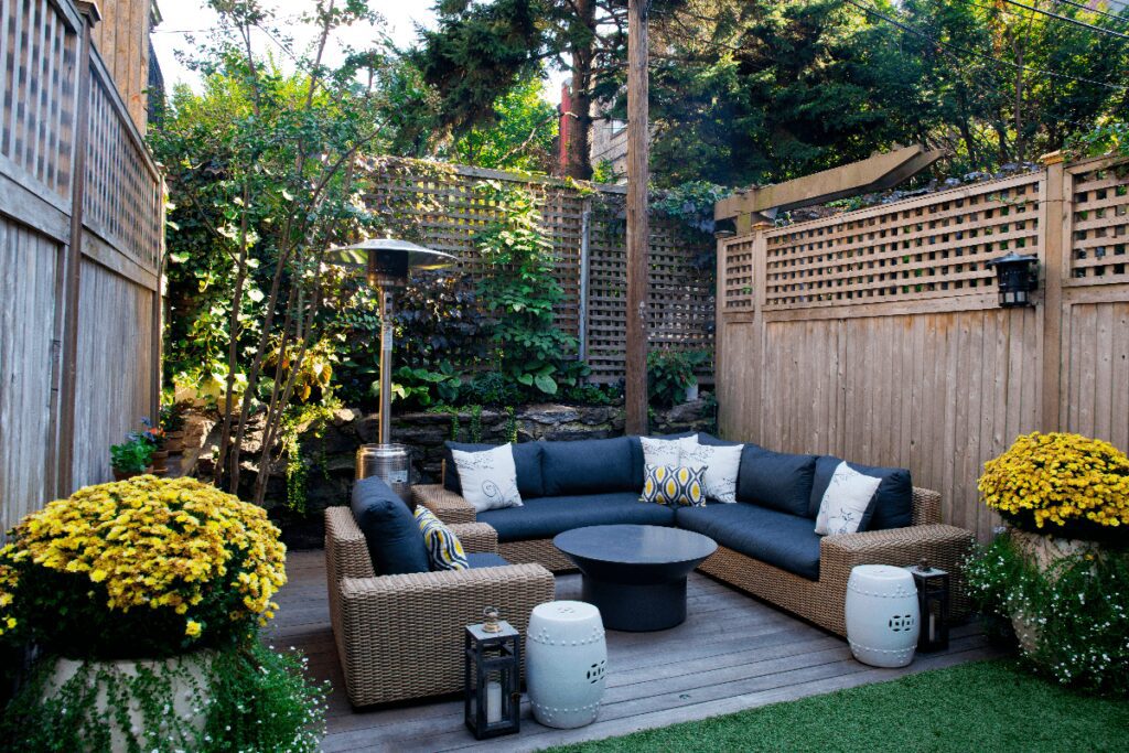 Outdoor seating area with couch and chairs and coffee table.