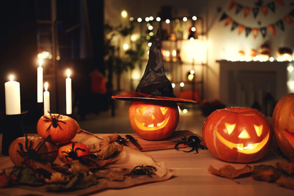 coffee table with jack o lanterns wearing witch hats, and candles