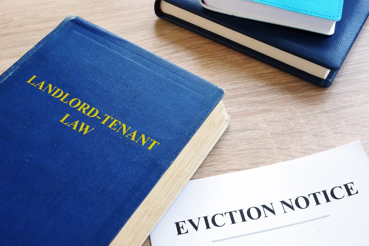 Landlord and tenant law book with eviction notice