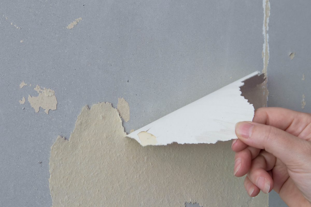 Peeling wallpaper is considered normal wear and tear.