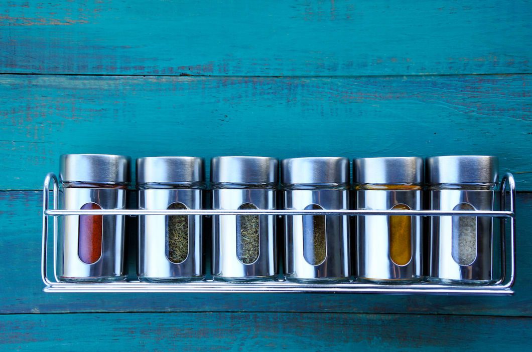 How to organize kitchen cabinets: Add clear containers, vertical storage and corner cabinets to avoid wasted space and unused space. Or place a spice rack in your cabinet doors